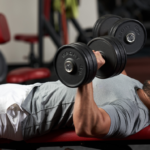 Man doing dumbbell bench press.