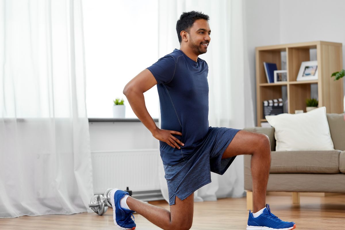 Man doing lunges in living room.