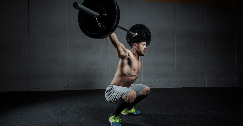Man doing snatch exercise.