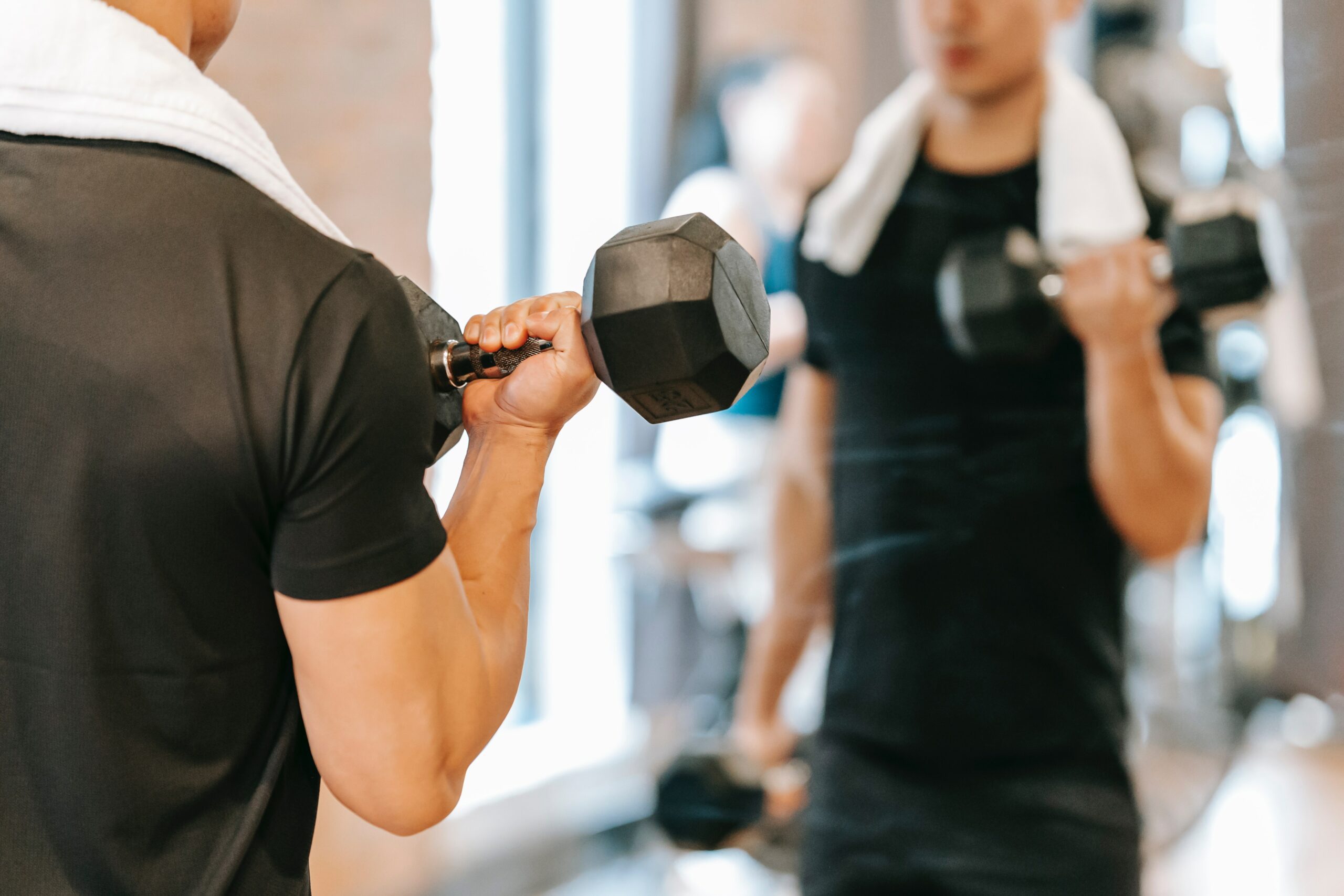 Man in mirror with dumbbells