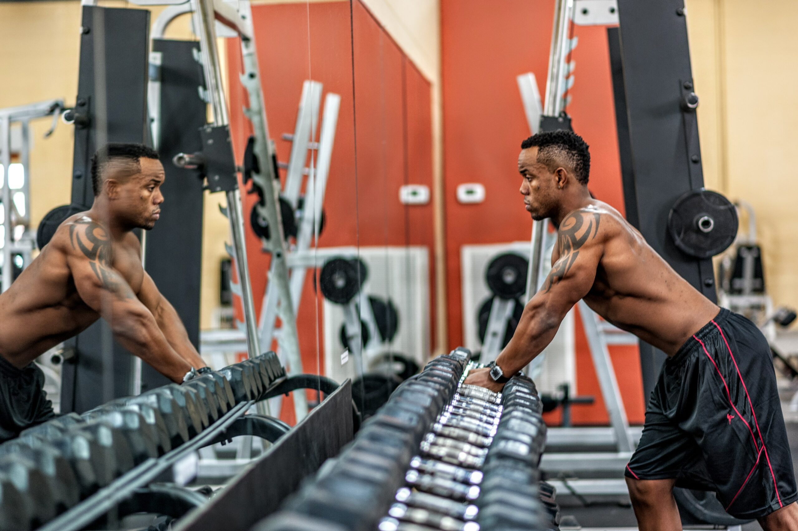 Man at dumbbell rack