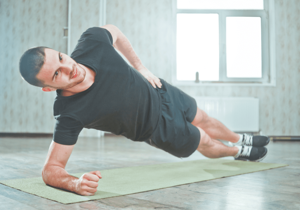 Man doing side plank core exercise.